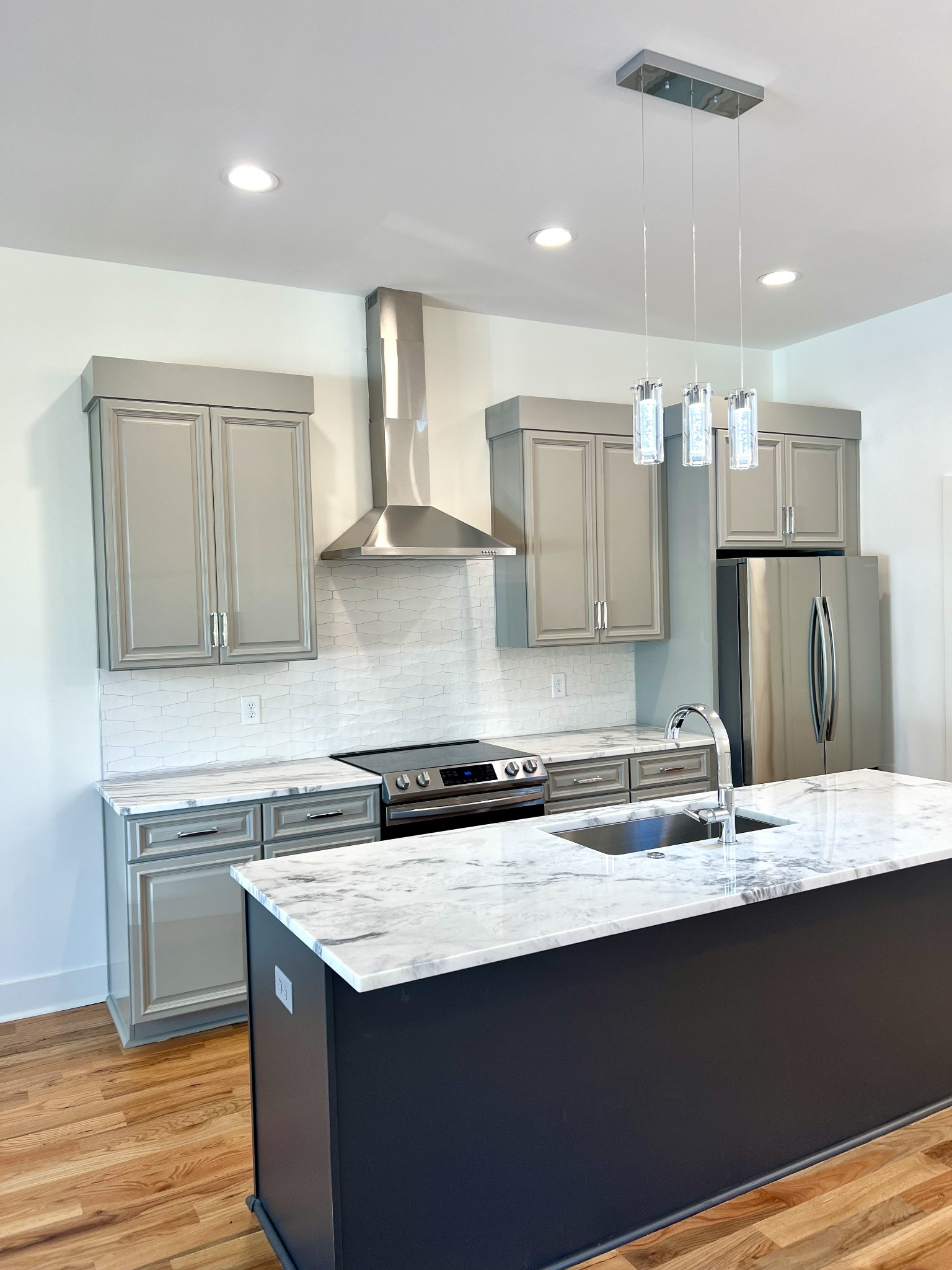 a kitchen with stainless steel appliances granite countertop a sink stove and refrigerator