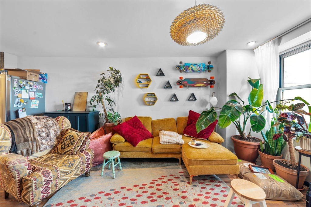 a living room with furniture and a potted plant