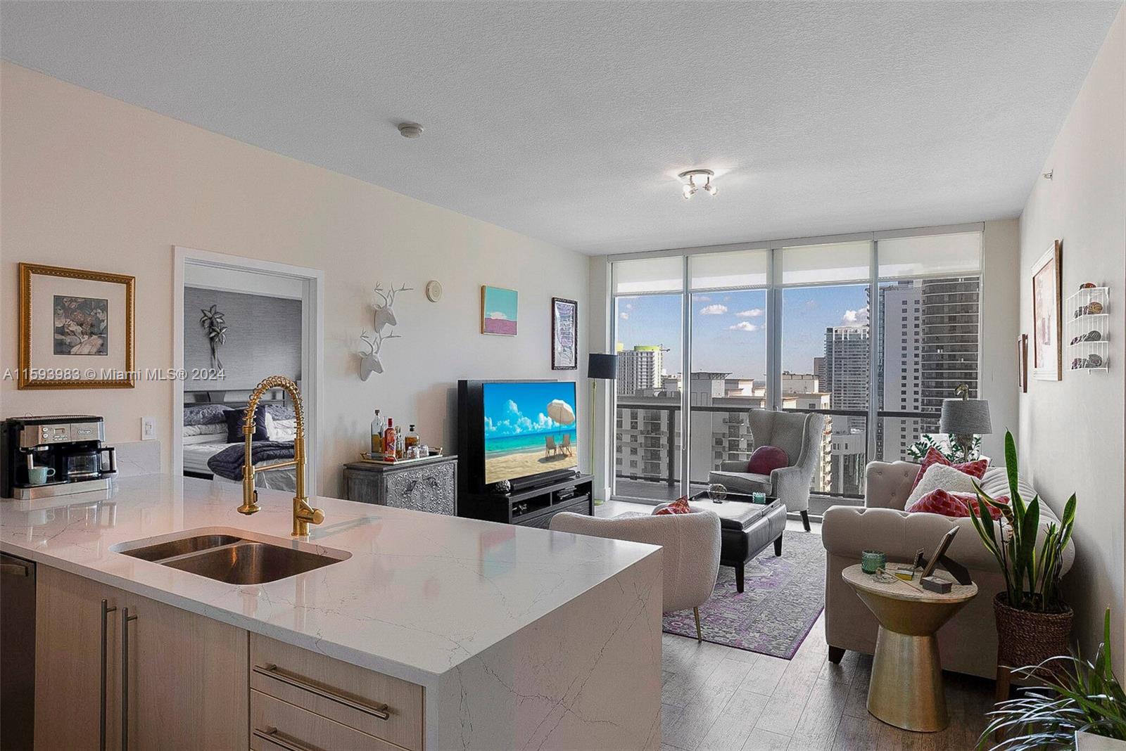 a living room with furniture a large window and a flat screen tv