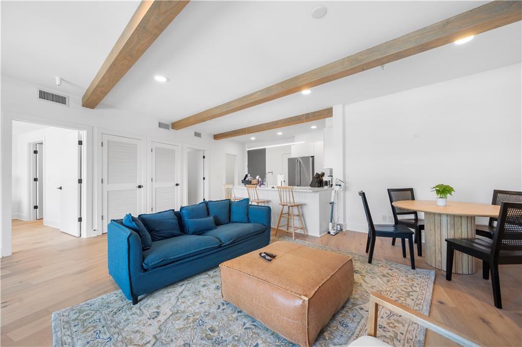 a living room with furniture a rug and a table