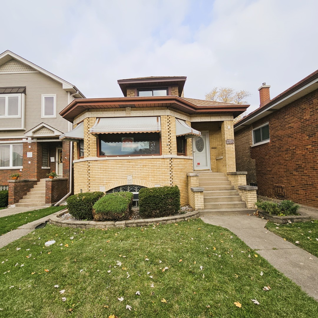 a front view of a house with a yard