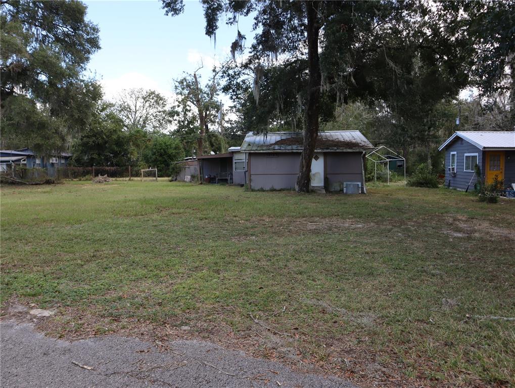 a big house with a big yard and large trees