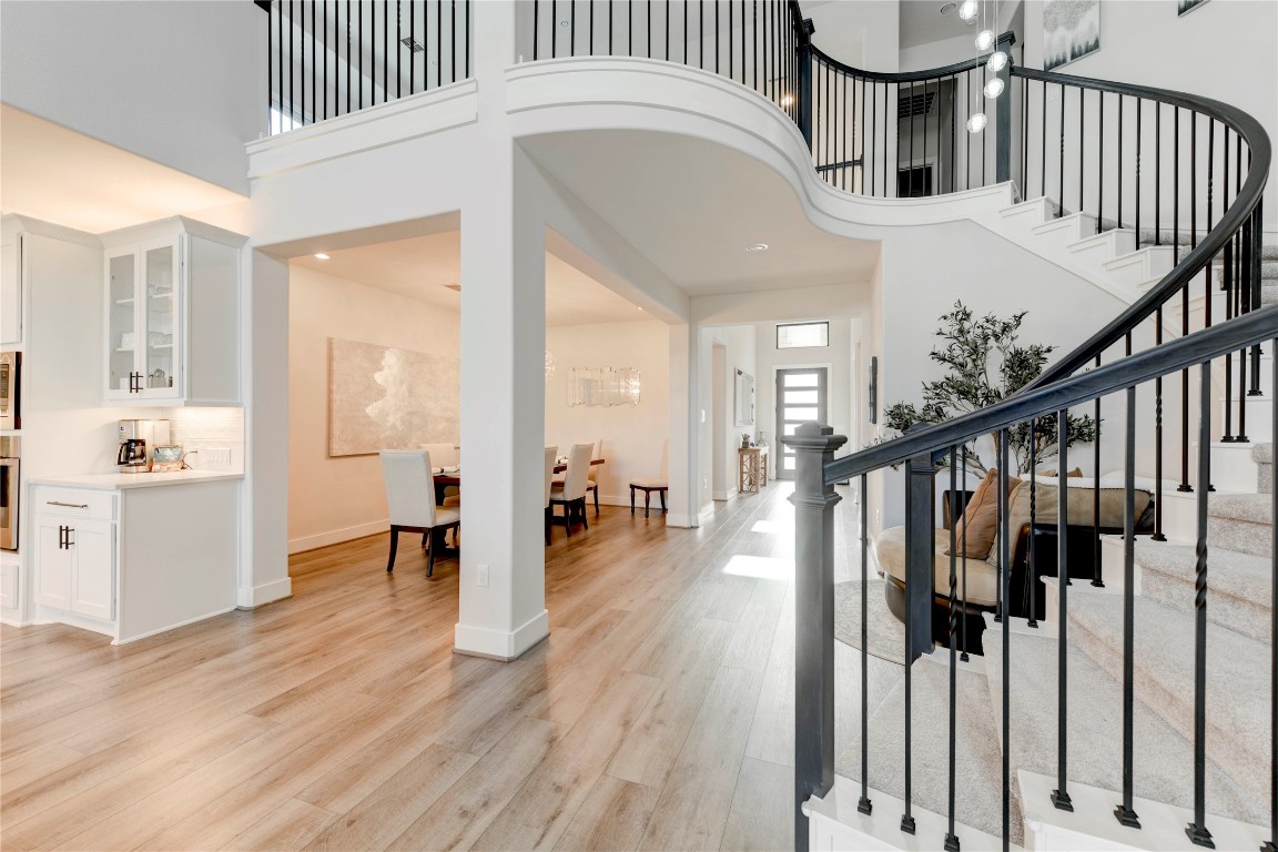 a view of entryway and hall with wooden floor