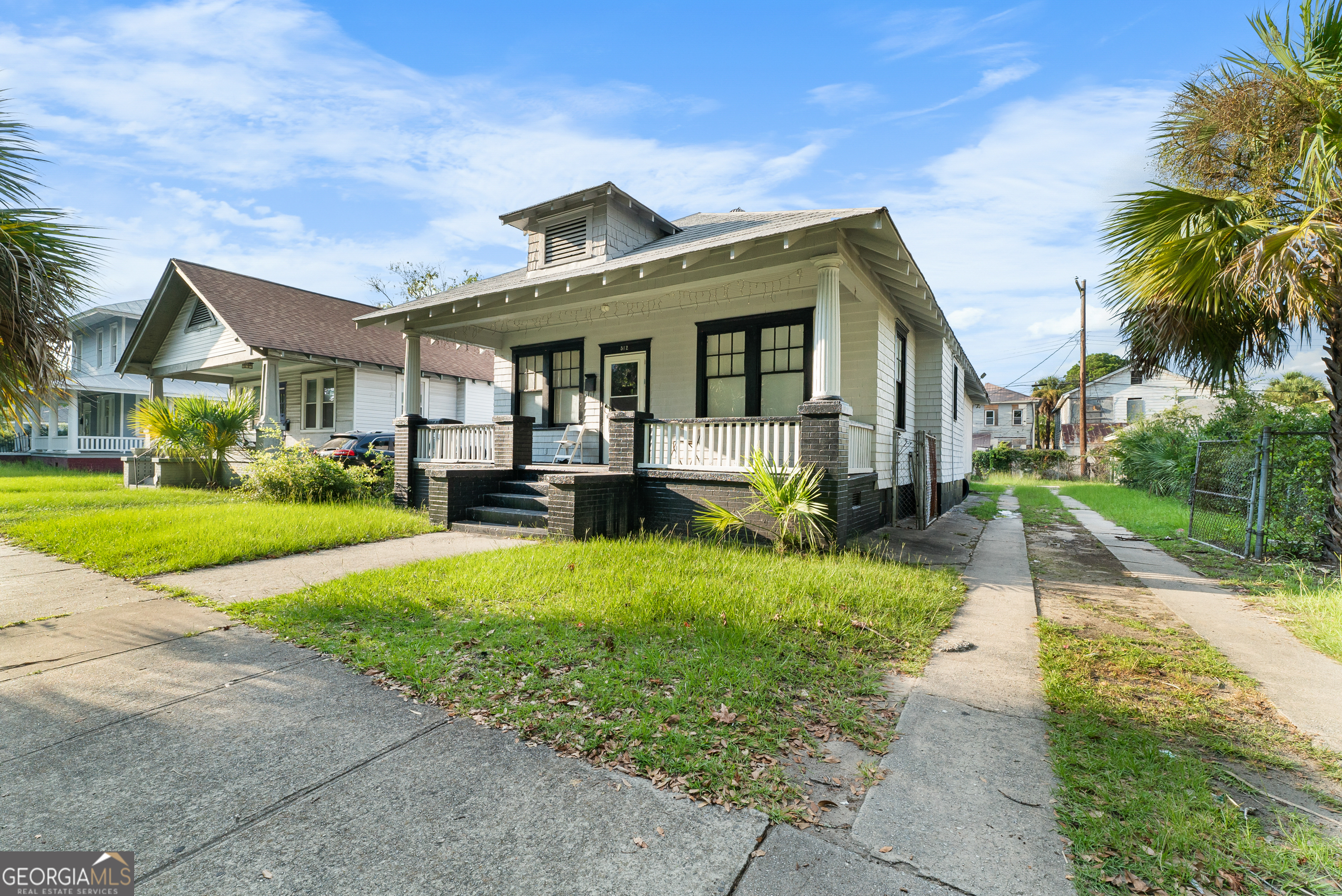 a front view of house with yard and green space