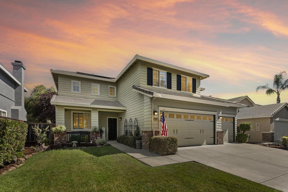 a front view of a house with a yard and garage