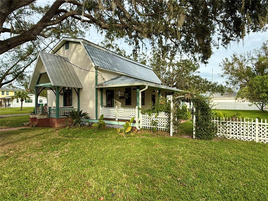 a front view of a house with a yard table and chairs