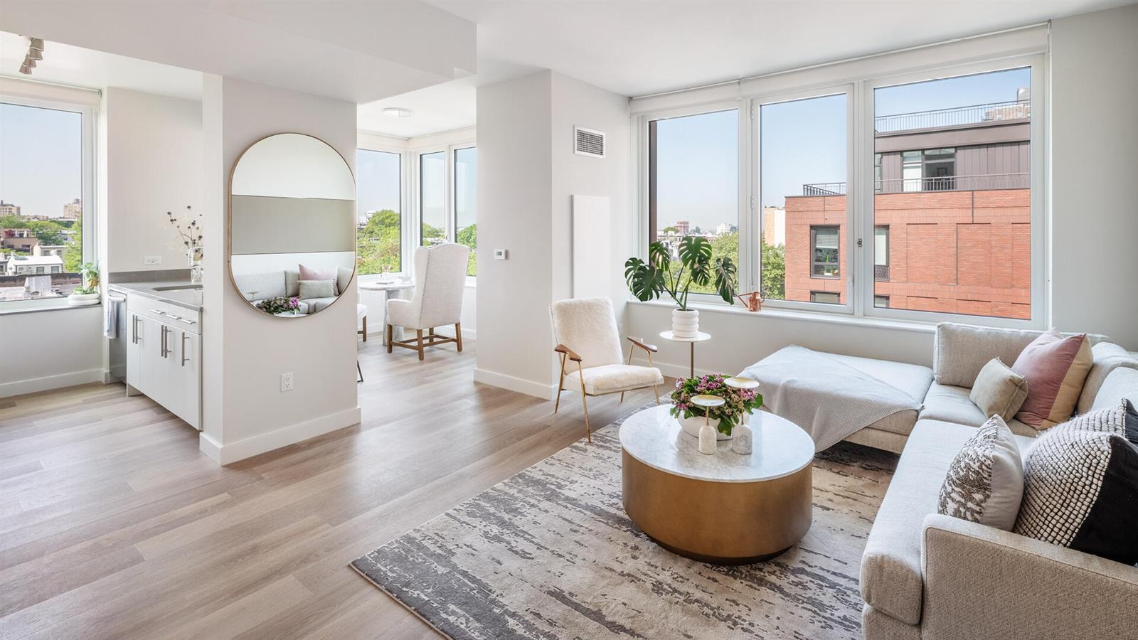 a living room with furniture and a potted plant