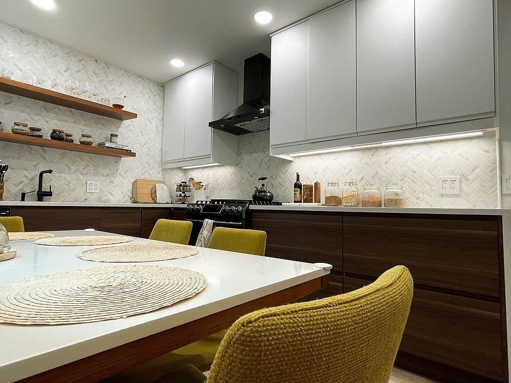 a kitchen with stainless steel appliances granite countertop a sink and white cabinets