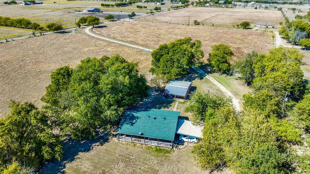 an aerial view of a house with a yard and lake view