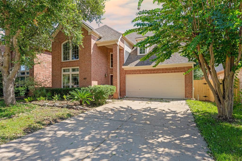 a front view of a house with a yard and a garage