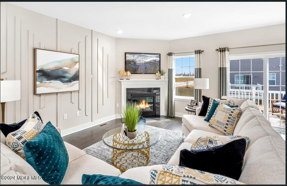 a living room with furniture large window and a fireplace