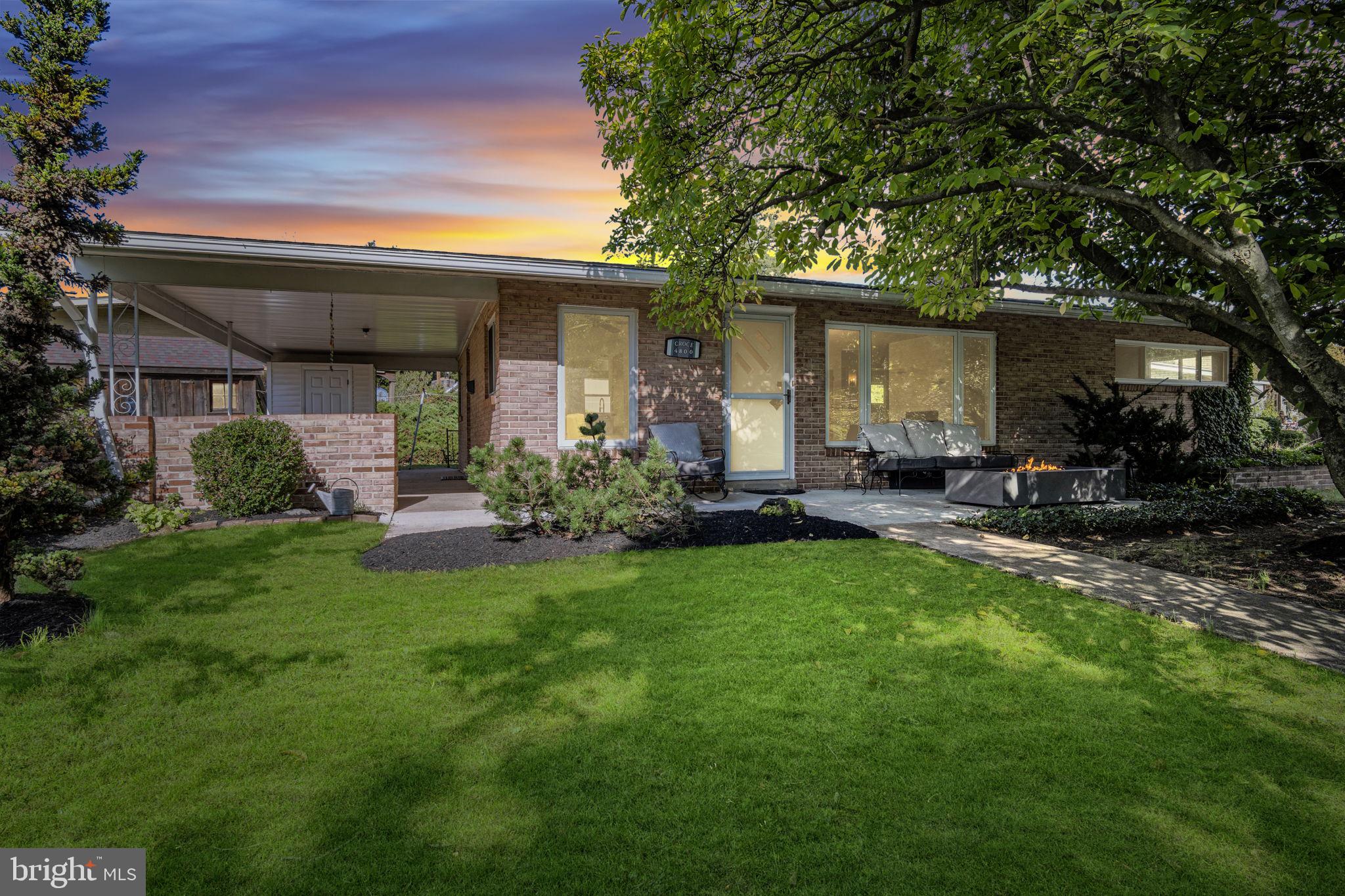 a front view of house with yard and outdoor seating