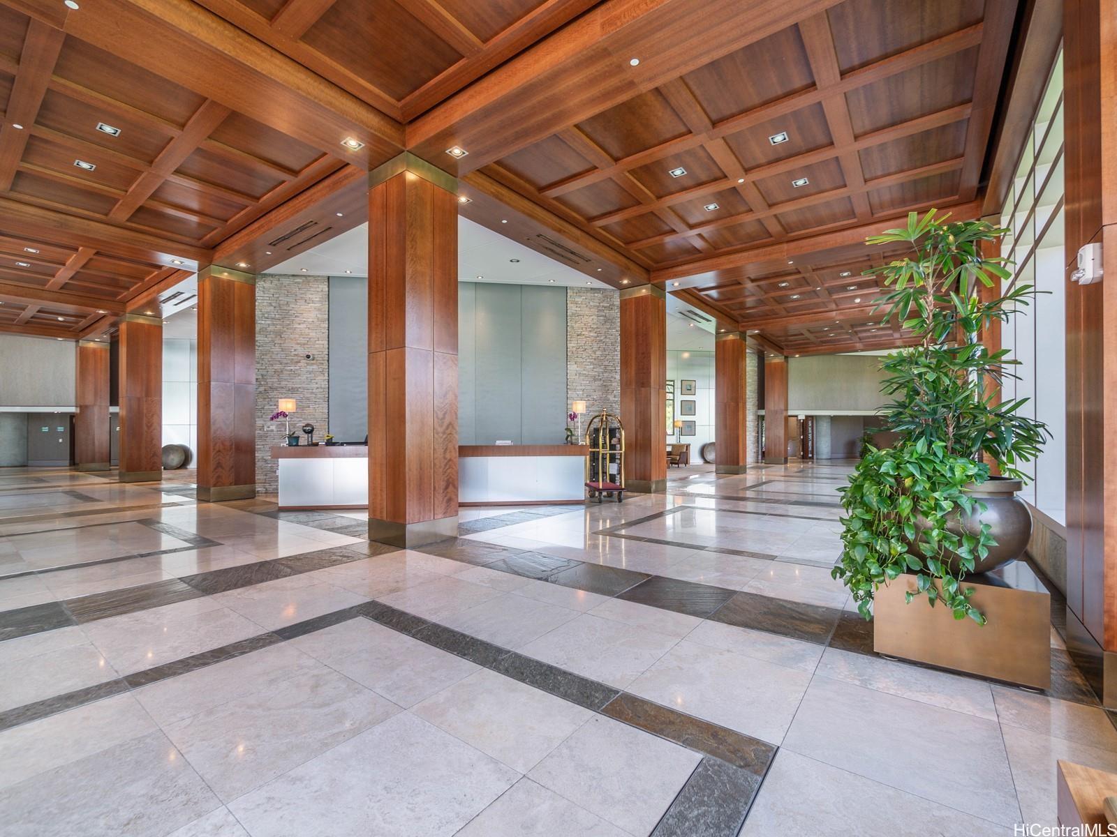 a view of lobby with a potted plant and floor to ceiling window