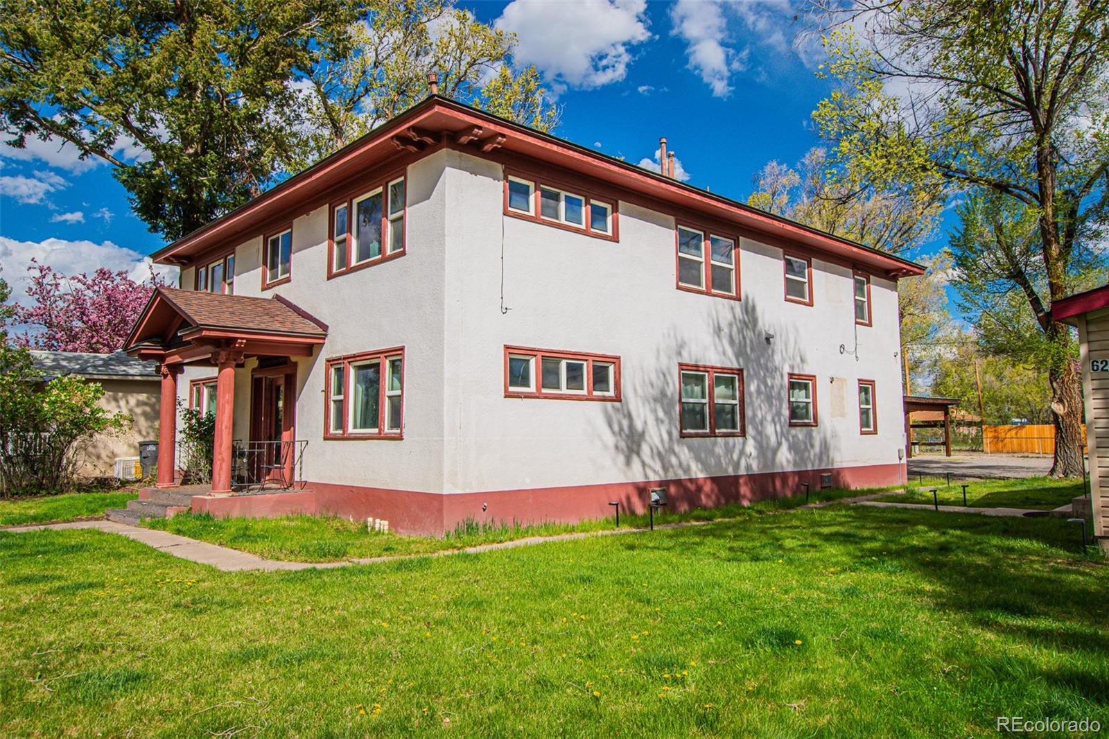 a front view of house with yard and green space