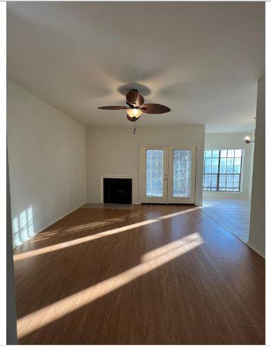 a living room with hardwood floor and a ceiling fan