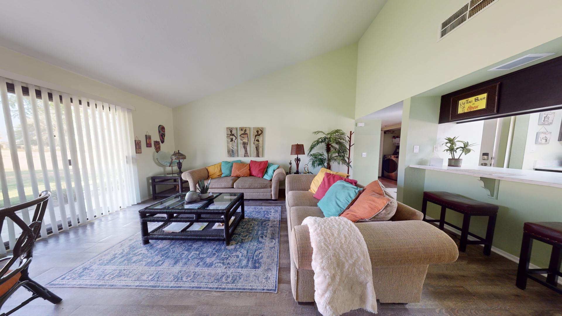 a living room with furniture and a potted plant