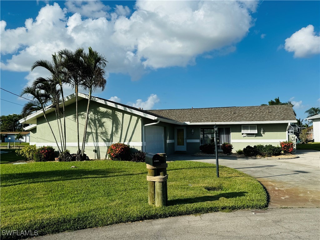 a front view of a house with garden and plants