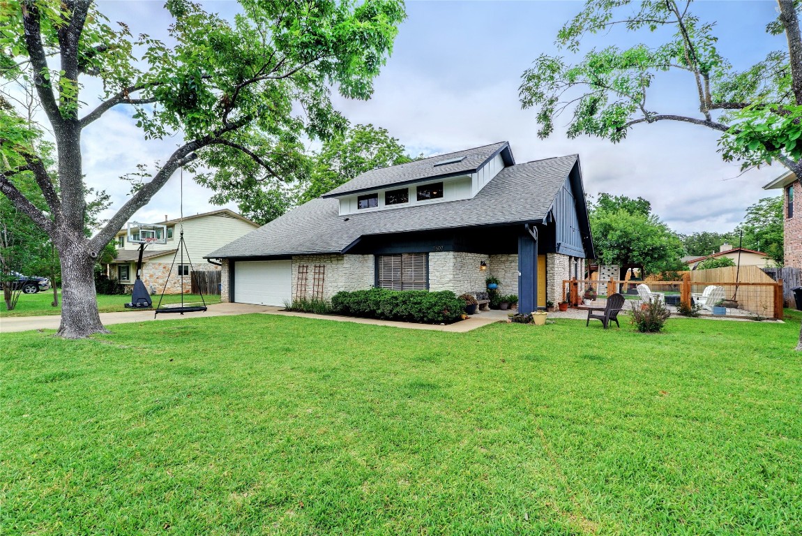 a front view of a house with a yard and trees