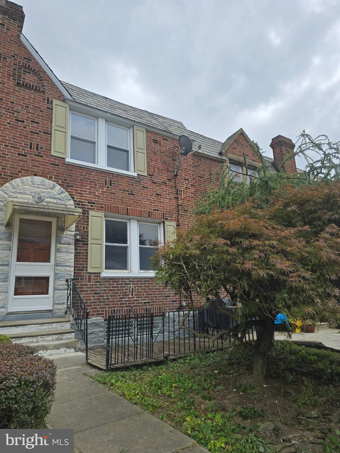 a view of a brick house with many windows