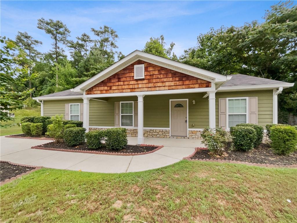 a front view of a house with yard and green space