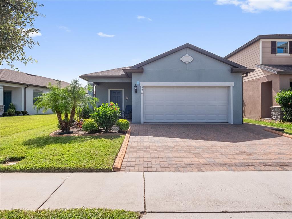 a front view of a house with a yard and garage