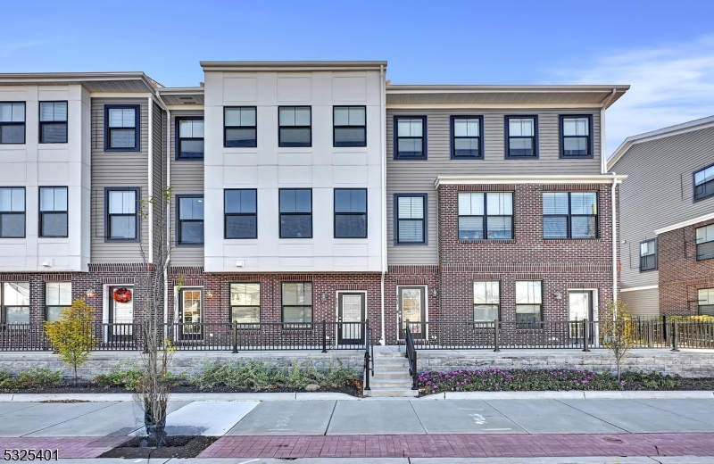 a front view of a residential apartment building with a yard