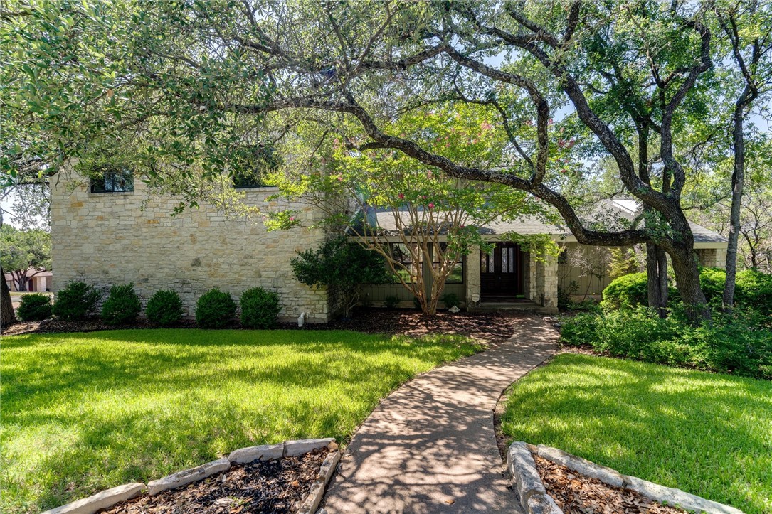 a front view of a house with garden