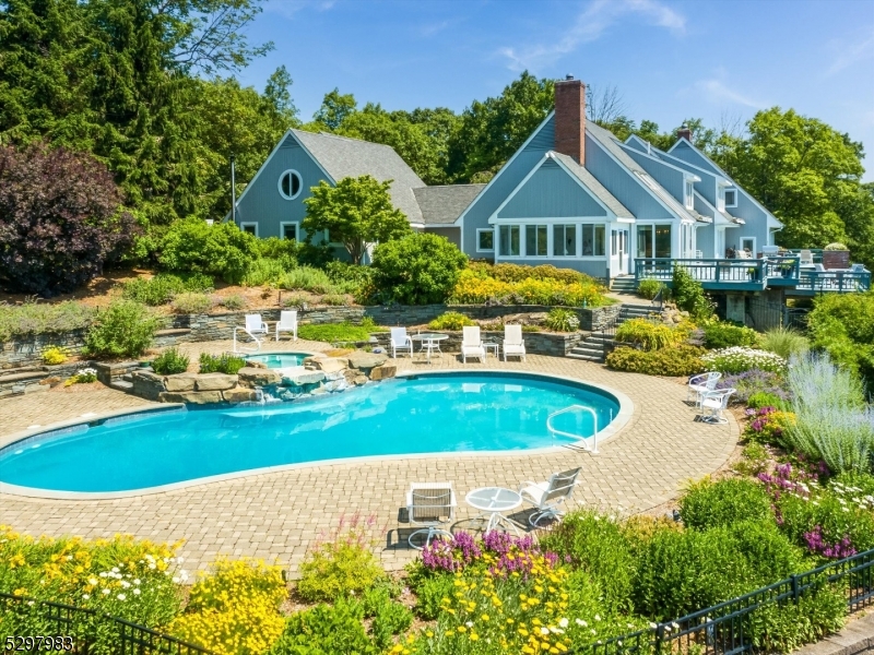 a view of a house with swimming pool and yard