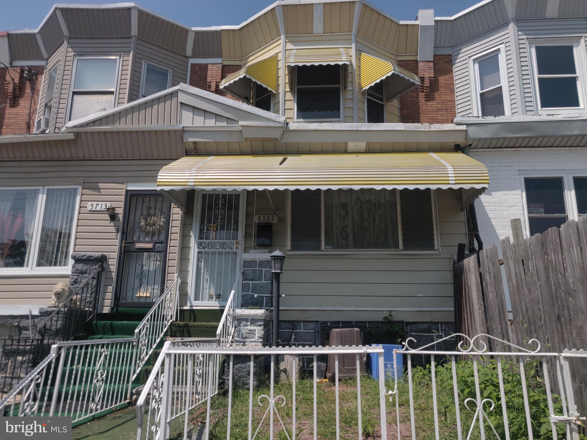 a view of house with front door and outdoor seating