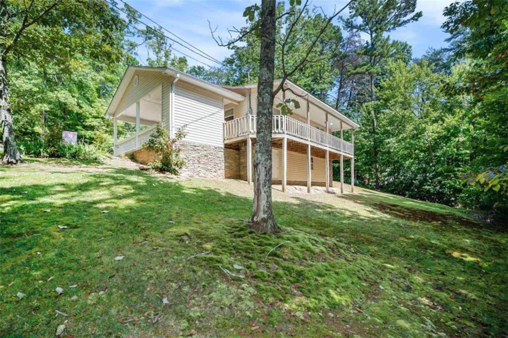 a view of a house with yard and a tree