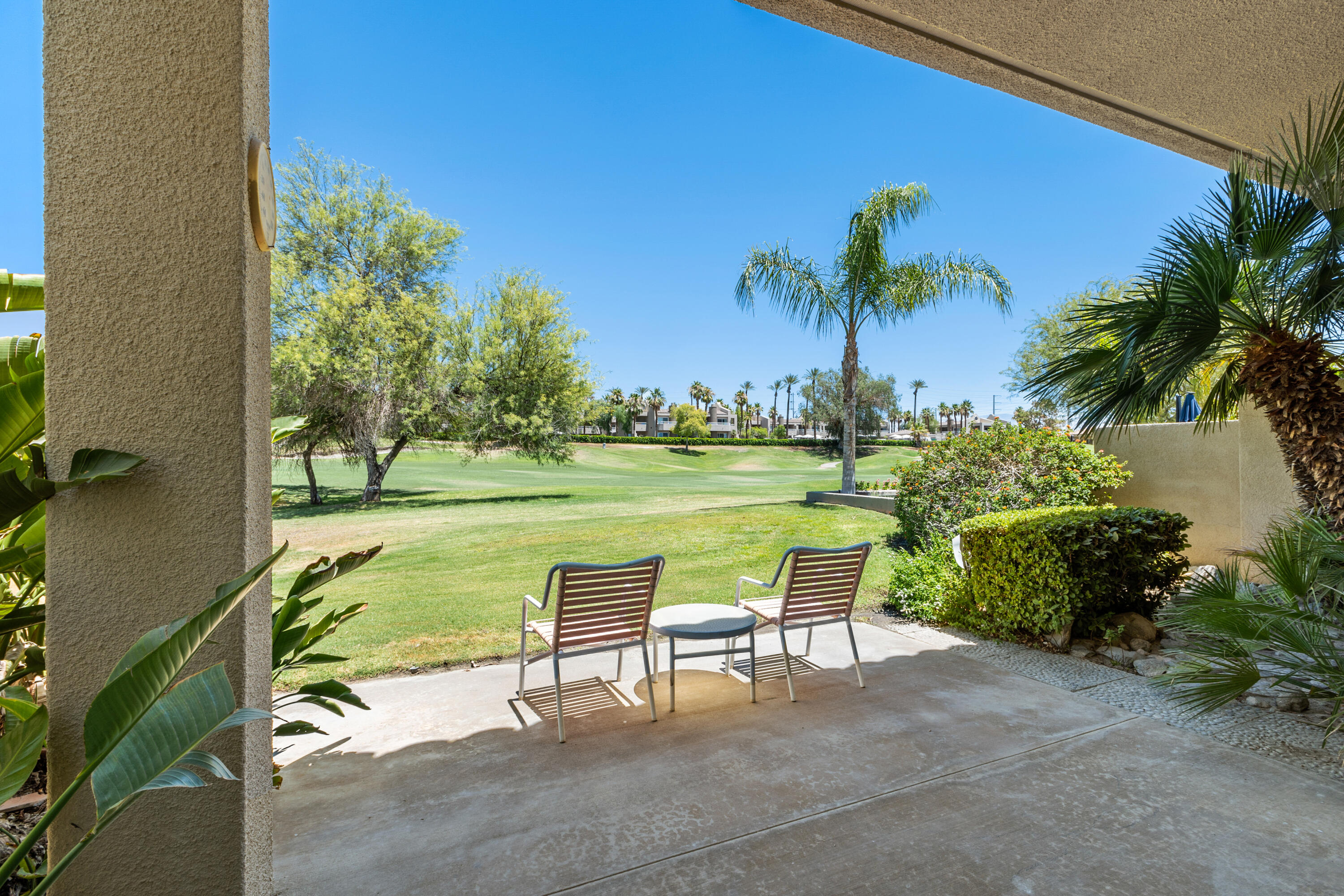 a view of a chairs and table in patio