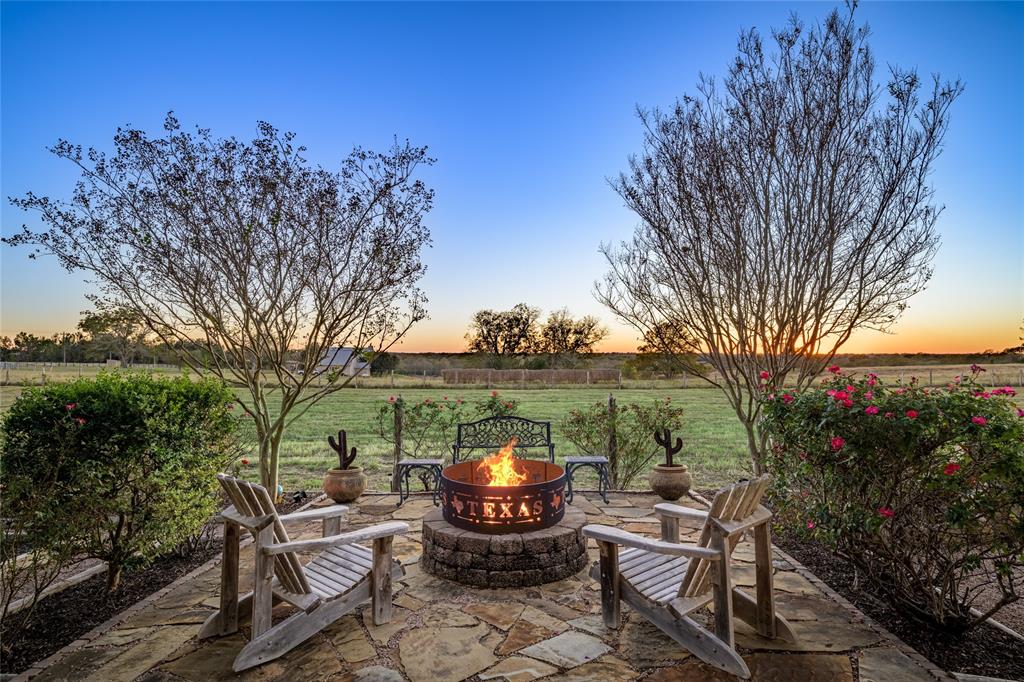 a view of a patio with iron fence