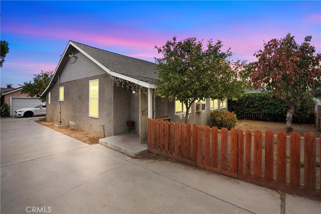 a front view of a house with wooden fence