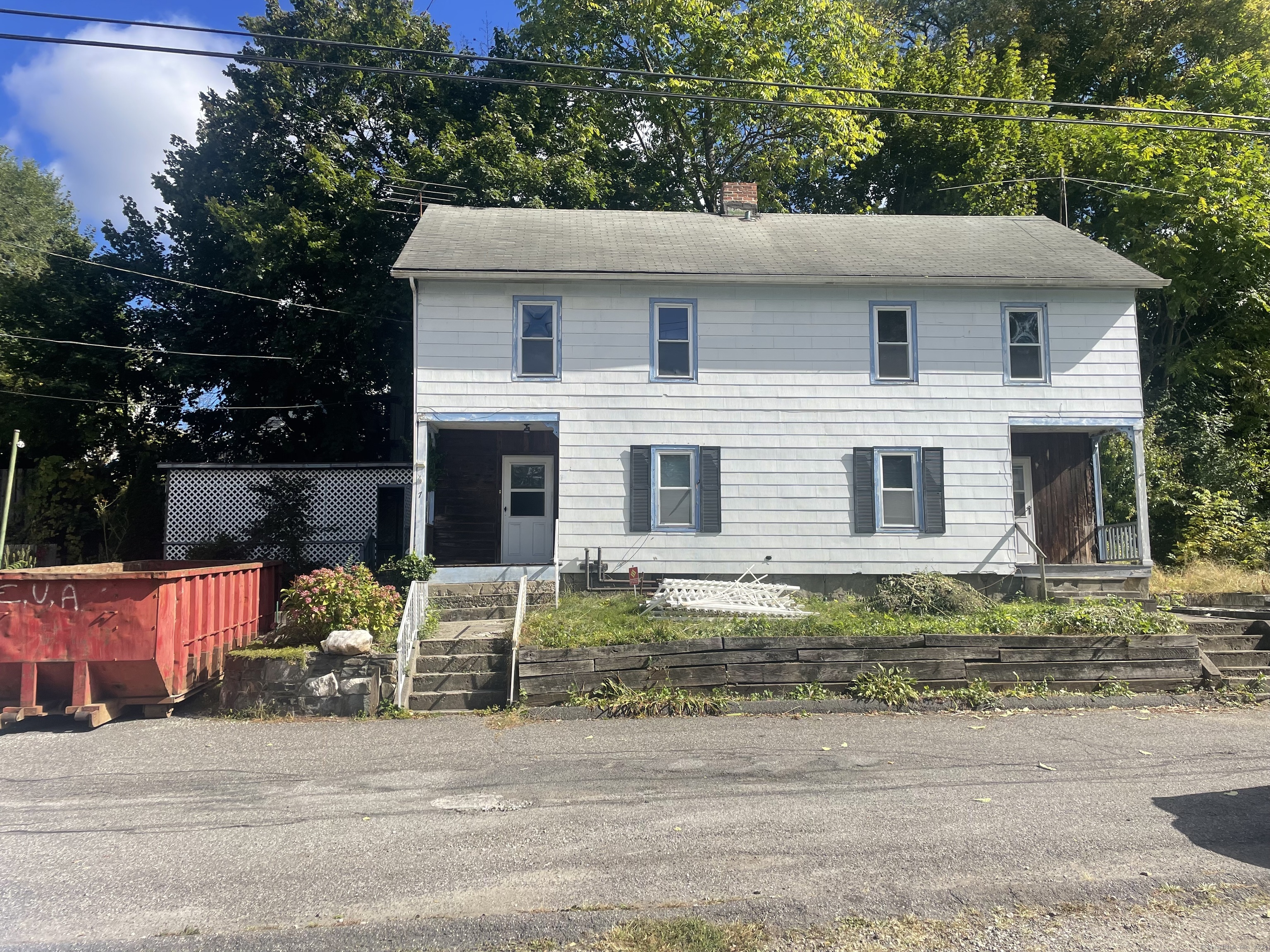 a view of a house with a yard and sitting area