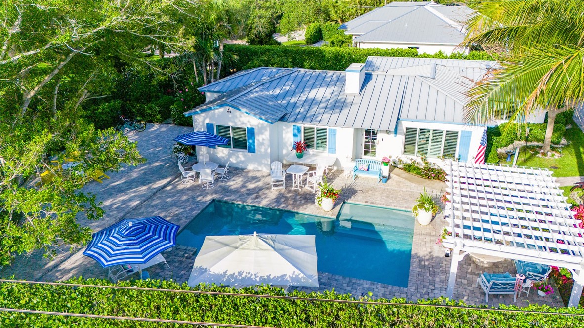 an aerial view of a house with garden space and patio