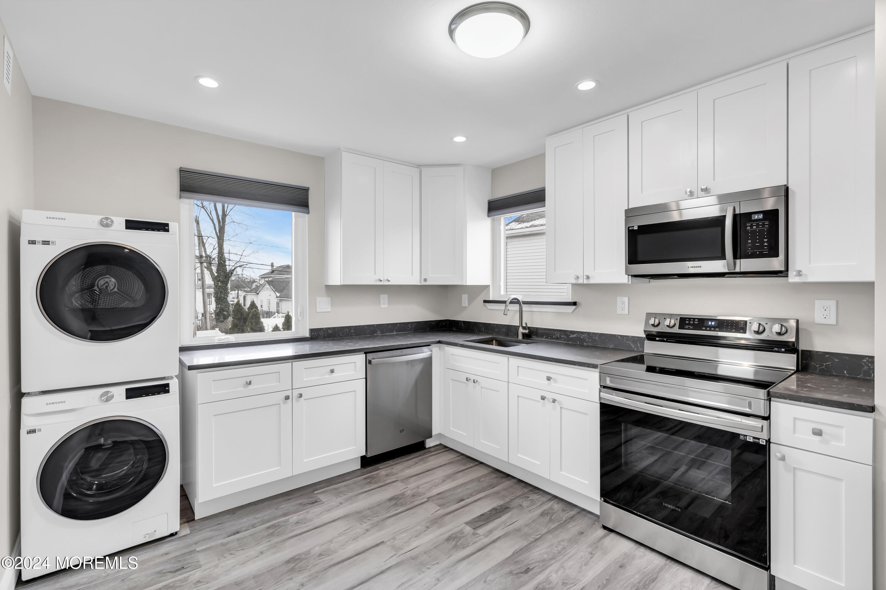 a kitchen with a sink a stove and cabinets