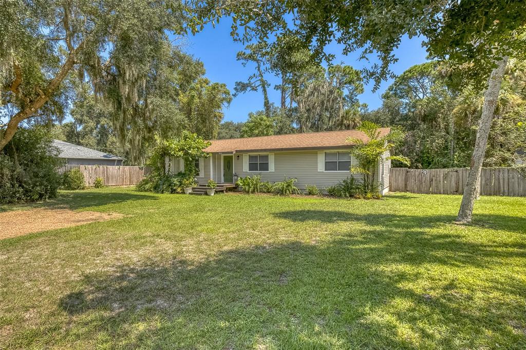 a view of a house with a backyard