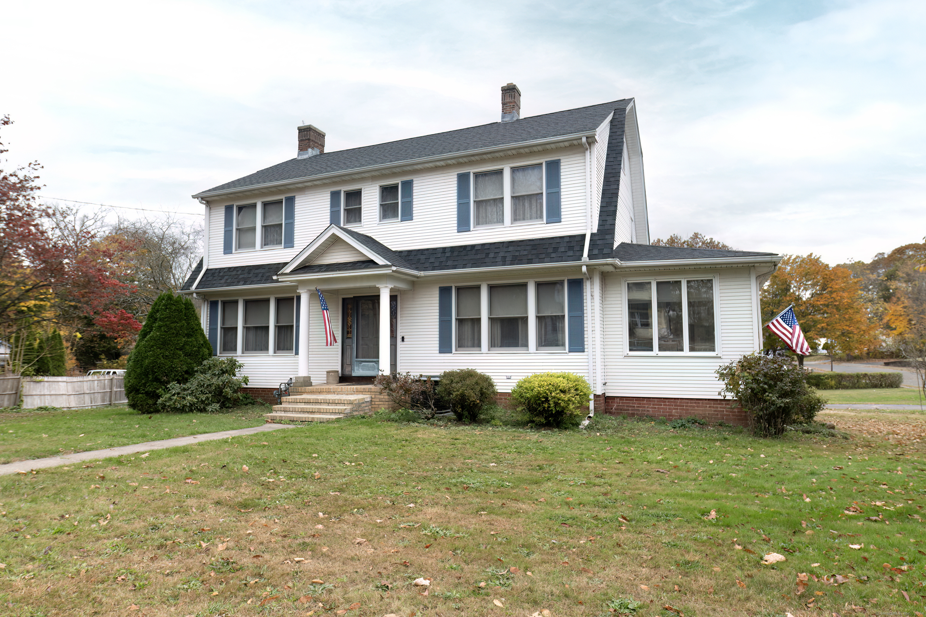 a front view of a house with a yard and porch