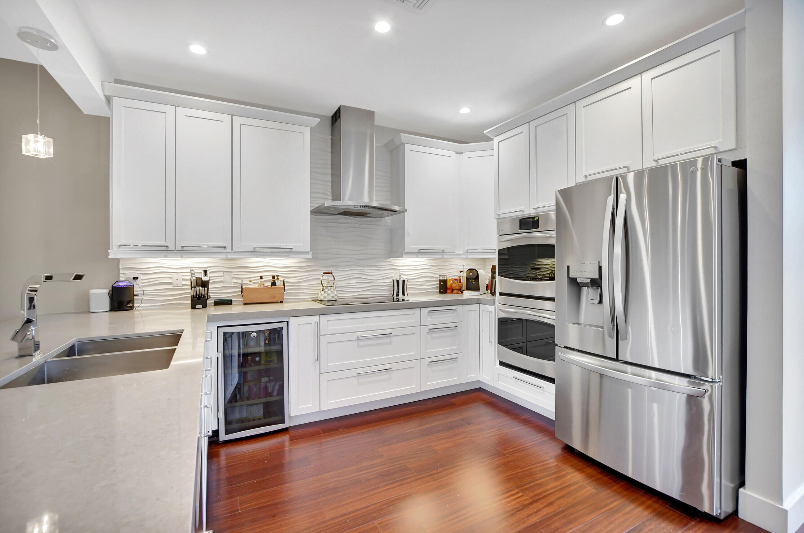 a kitchen with granite countertop white cabinets and stainless steel appliances