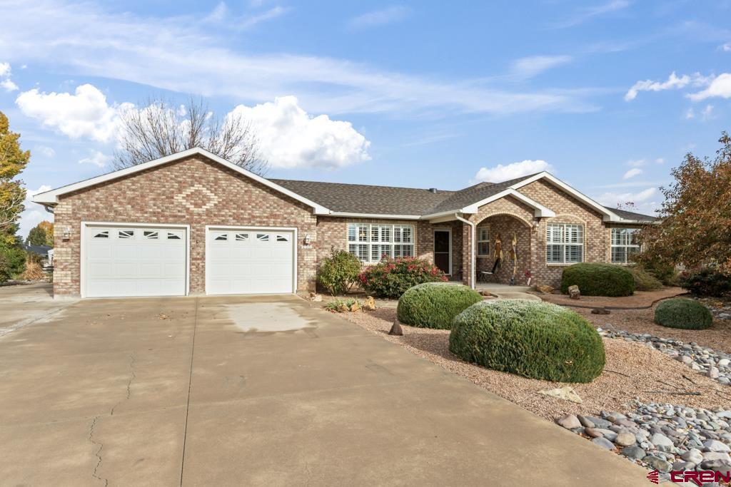 a view of a house with a yard and garage