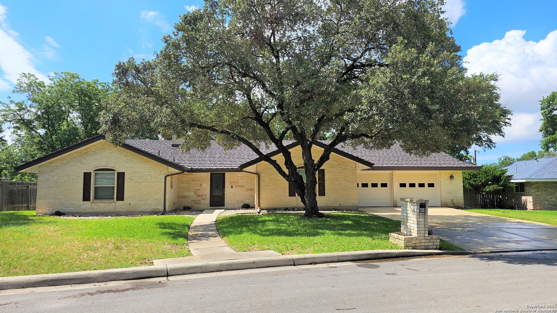 a view of house with a yard and street