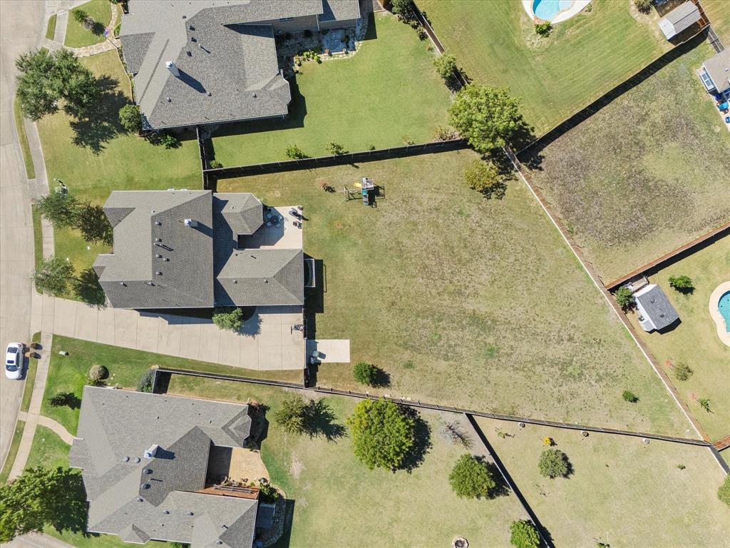 an aerial view of a house with a swimming pool