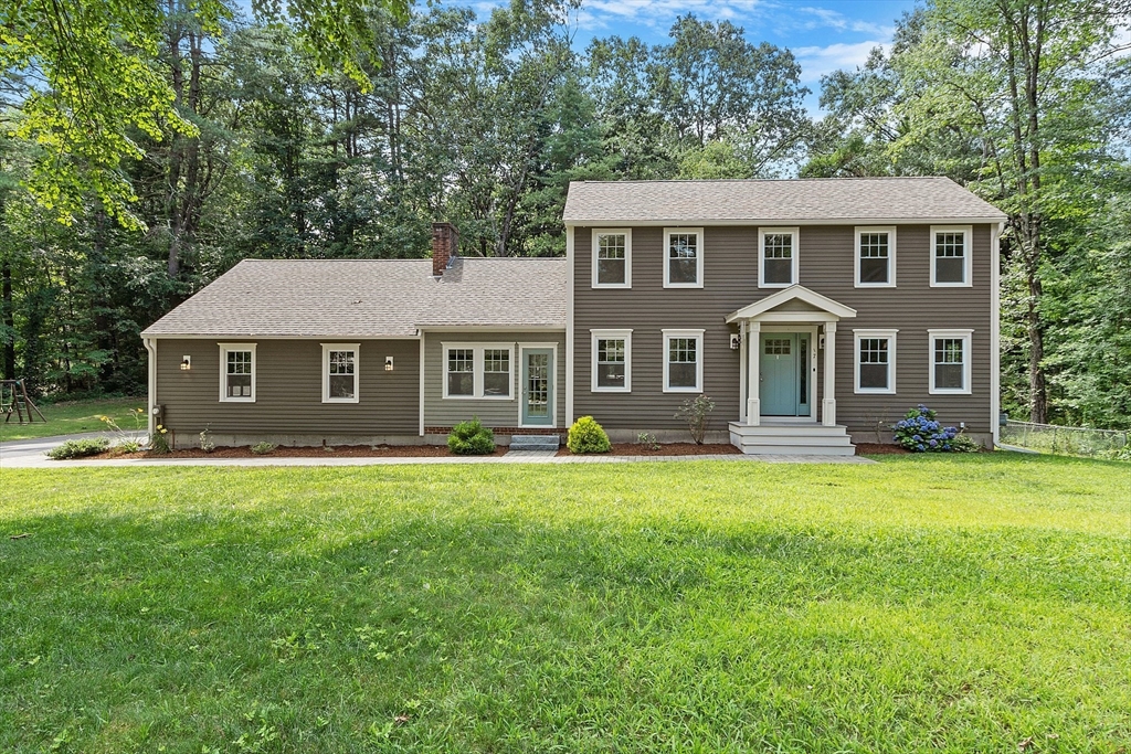 a front view of a house with a garden and porch