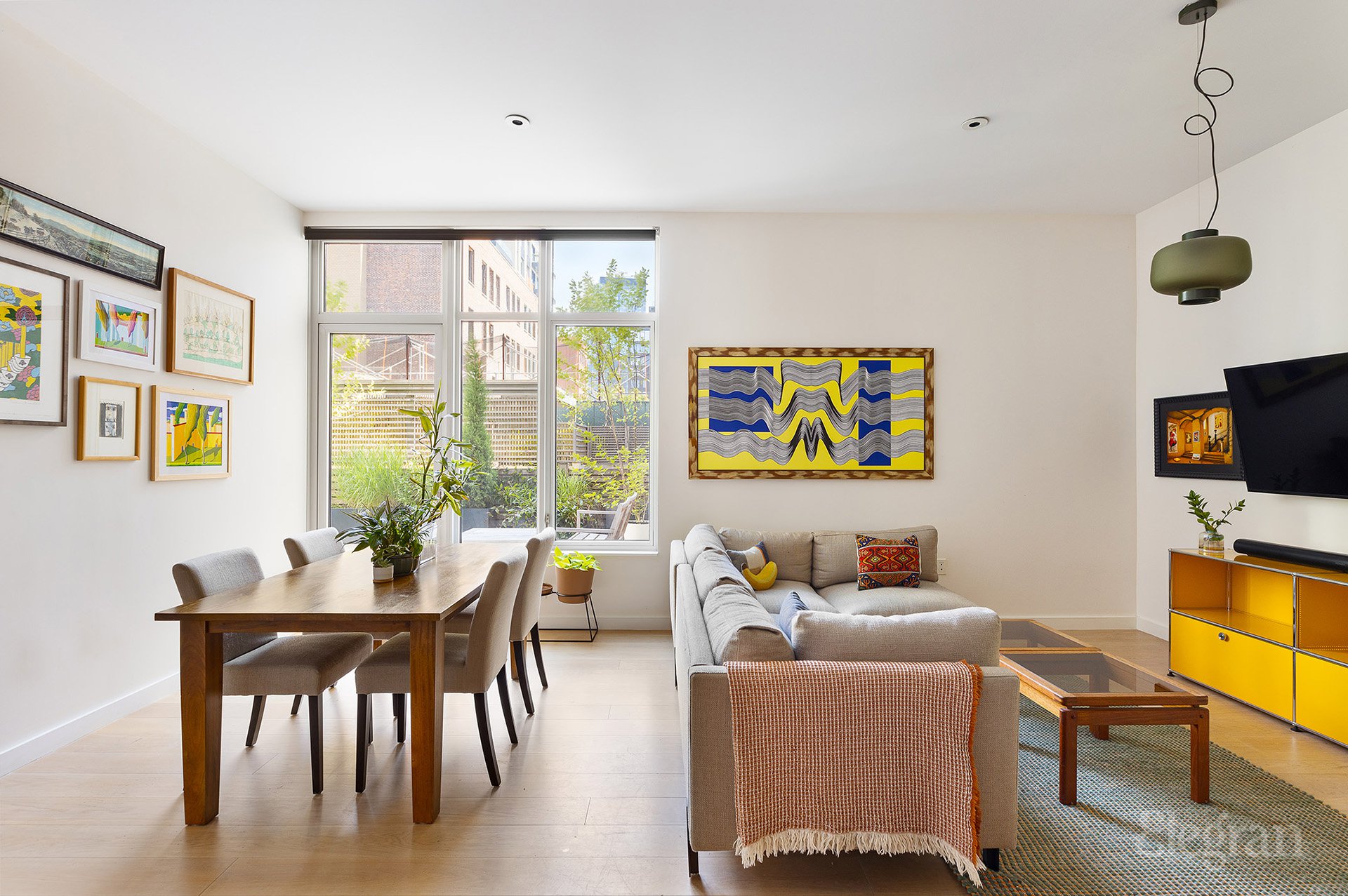 a living room with furniture and a flat screen tv