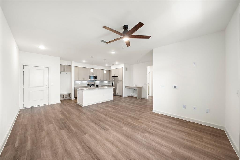 a view of a kitchen with a sink and wooden floor