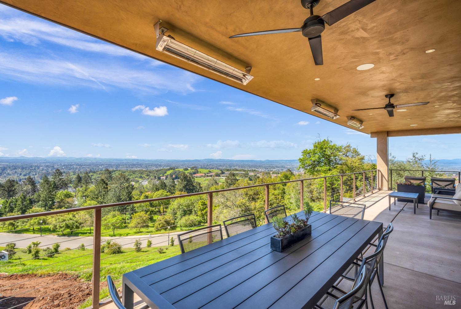 a view of a chairs and table on the wooden deck