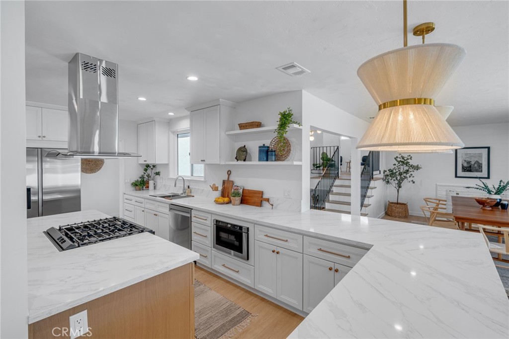 a kitchen with a stove a refrigerator and a sink