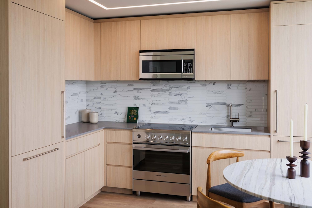 a kitchen with granite countertop white cabinets stainless steel appliances and sink