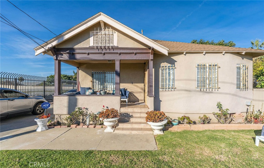 a view of a house with backyard porch and sitting area