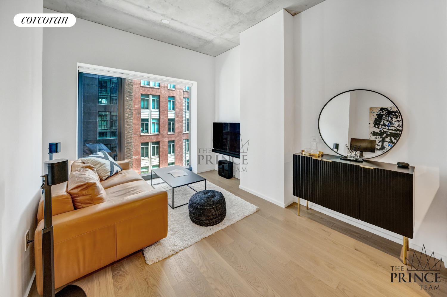 a living room with furniture a flat screen tv and a floor to ceiling window